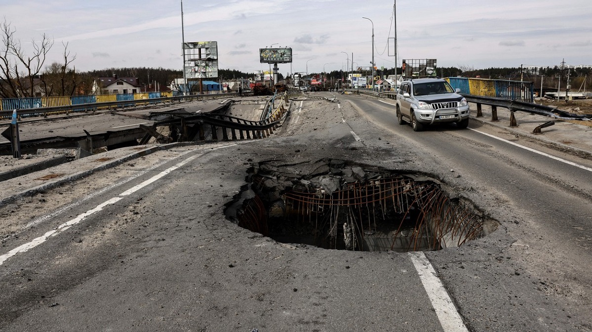 A vehicle drives past a hole on a damaged bridge, in the outskirts of Kyiv on April 8, 2022.,Image: 681270665, License: Rights-managed, Restrictions: , Model Release: no, Credit line: Profimedia