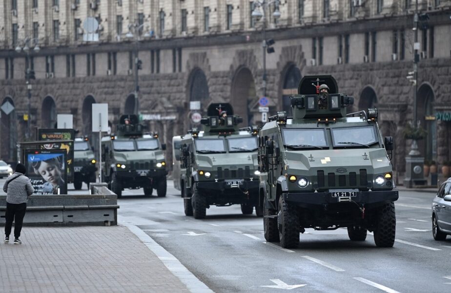 Ukrainian military vehicles move past Independence square in central Kyiv on February 24, 2022. Air raid sirens rang out in downtown Kyiv today as cities across Ukraine were hit with what Ukrainian officials said were Russian missile strikes and artillery. Russian President announced a military operation in Ukraine on February 24, 2022, with explosions heard soon after across the country and its foreign minister warning a 