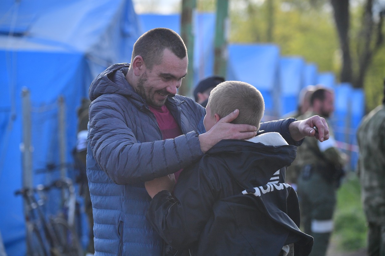 8181293 01.05.2022 A man hugs a boy in an aid post for evacuees from Mariupol, who lives close to the plant of Azovstal Iron and Steel Works, in Bezymennoe village, Donetsk People's Republic. In the aid people get accommodation, food and medical help.,Image: 687725319, License: Rights-managed, Restrictions: Editors' note: THIS IMAGE IS PROVIDED BY RUSSIAN STATE-OWNED AGENCY SPUTNIK., Model Release: no, Credit line: Profimedia