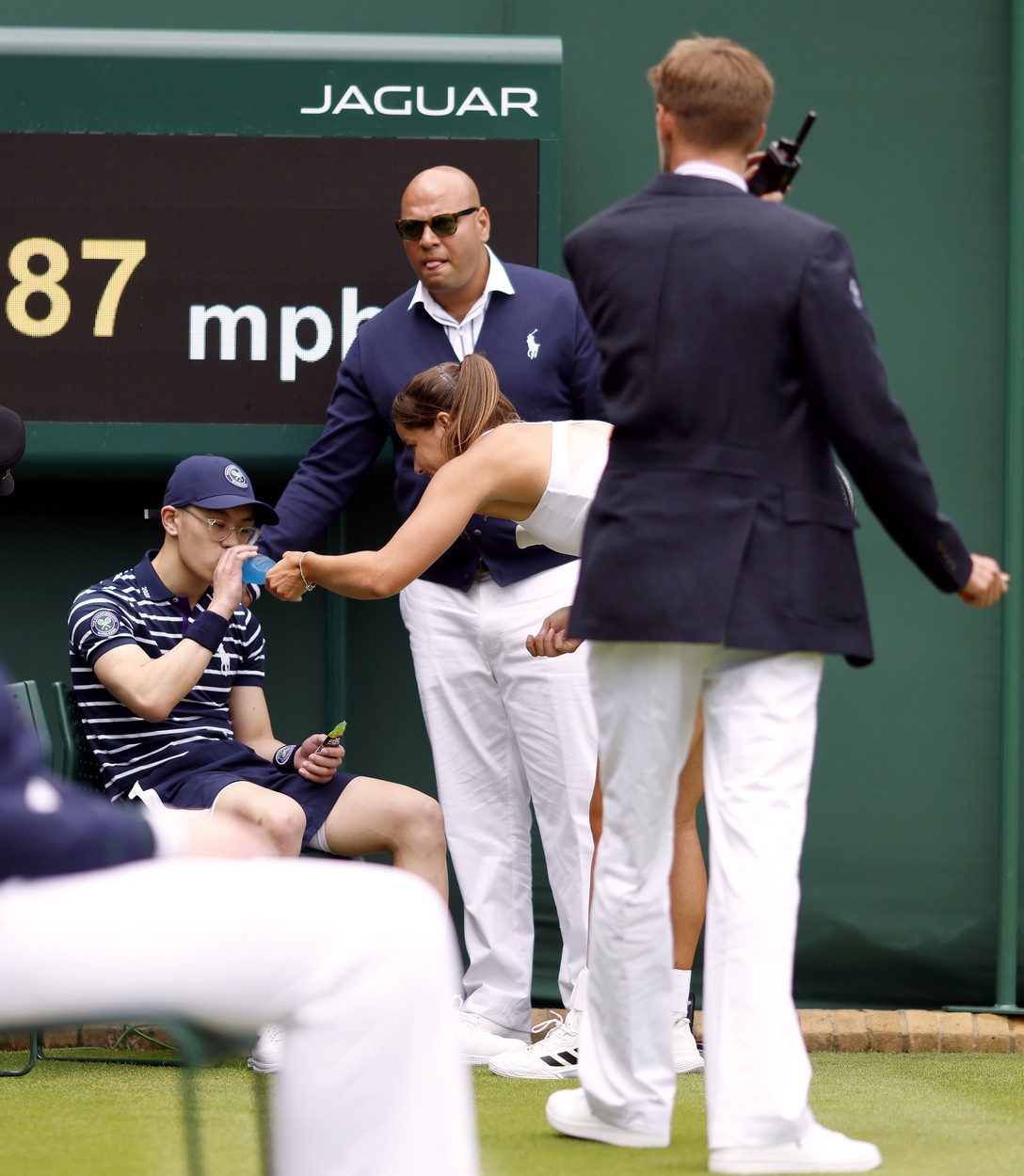 Jodie Burrage helps a ball boy after they fainted during her Ladies' singles first round match against Lesia Tsurenko during day one of the 2022 Wimbledon Championships at the All England Lawn Tennis and Croquet Club, Wimbledon. Picture date: Monday June 27, 2022.,Image: 703167984, License: Rights-managed, Restrictions: Editorial use only. No commercial use without prior written consent of the AELTC. Still image use only - no moving images to emulate broadcast. No superimposing or removal of sponsor/ad logos., Model Release: no, Credit line: Profimedia