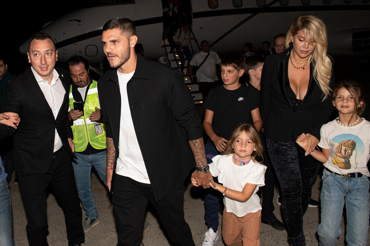 This handout photograph taken and released on September 8, 2022 shows Paris Saint-Germain's Argentinian forward Mauro Icardi (L) and his wife, Argentinian actress Wanda Nara (R), arriving at the Ataturk Airport in Istanbul.,Image: 720536213, License: Rights-managed, Restrictions: RESTRICTED TO EDITORIAL USE - MANDATORY CREDIT 