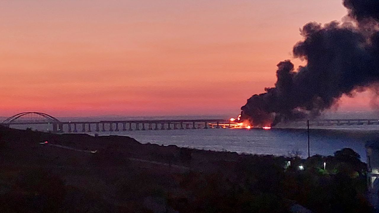 8291765 08.10.2022 A view shows a smoke rising from Crimean Bridge connecting Russian mainland and Crimean peninsula over the Kerch Strait, in Crimea, Russia. Russia's National Antiterrorism Committee (NAC) said on Saturday that a truck was blown up on the Crimean Bridge, which caused an inflammation of seven fuel tanks of a railway train and a partial collapse of two car spans. The traffic and movement of trains across the Kerch Strait was temporarily suspended. The movement of ships in the Kerch Strait did not stop despite a fire on the bridge. Sputnik