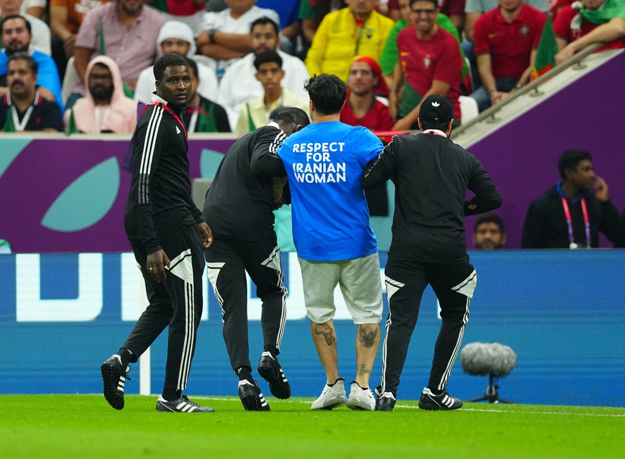 Pitch invader displaying a political message.
Portugal v Uruguay, FIFA World Cup 2022, Group H, Football, Lusail Stadium, Al Daayen, Qatar - 28 Nov 2022,Image: 740789333, License: Rights-managed, Restrictions: Editorial Use Only, Model Release: no