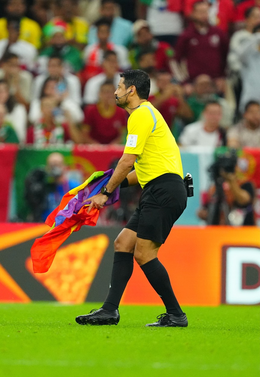Referee Mr Faghani Aliireza of Iran picks up a rainbow flag from the pitch invader.
Portugal v Uruguay, FIFA World Cup 2022, Group H, Football, Lusail Stadium, Al Daayen, Qatar - 28 Nov 2022,Image: 740789449, License: Rights-managed, Restrictions: Editorial Use Only, Model Release: no