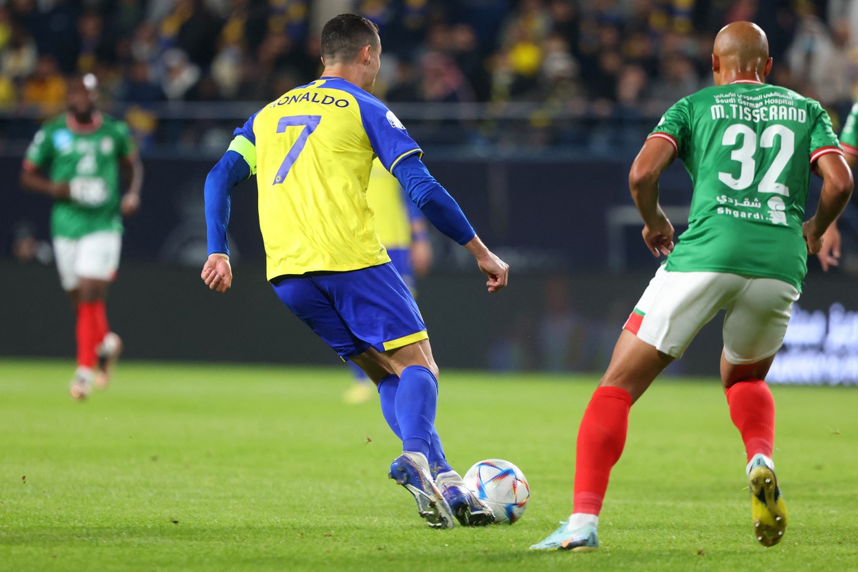 Nassr's Portuguese forward Cristiano Ronaldo (L) controls the ball as he is marked by Ettifaq's Congolese defender Marcel Tisserand during the Saudi Pro League football match between Al-Nassr and Al-Ettifaq at the King Fahd Stadium in the Saudi capital Riyadh on January 22, 2023.,Image: 751085307, License: Rights-managed, Restrictions: , Model Release: no