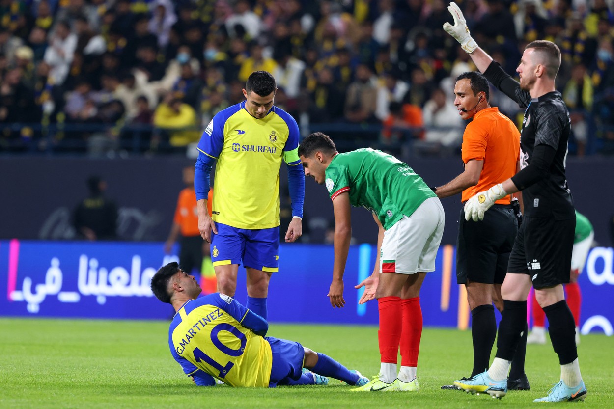 Nassr's Portuguese forward Cristiano Ronaldo (C) checks on teammate Nassr's Argentine midfielder Pity Martinez (L) during the Saudi Pro League football match between Al-Nassr and Al-Ettifaq at the King Fahd Stadium in the Saudi capital Riyadh on January 22, 2023.,Image: 751085310, License: Rights-managed, Restrictions: , Model Release: no