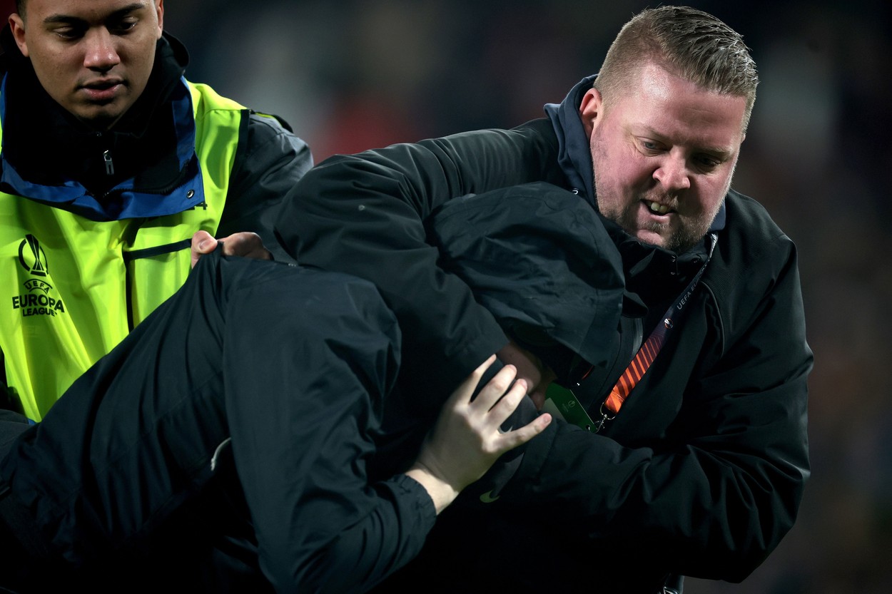 EINDHOVEN - A supporter is taken off the pitch during the UEFA Europa league playoff match between PSV Eindhoven and Sevilla FC at Phillips stadium on February 23, 2023 in Eindhoven, Netherlands.
