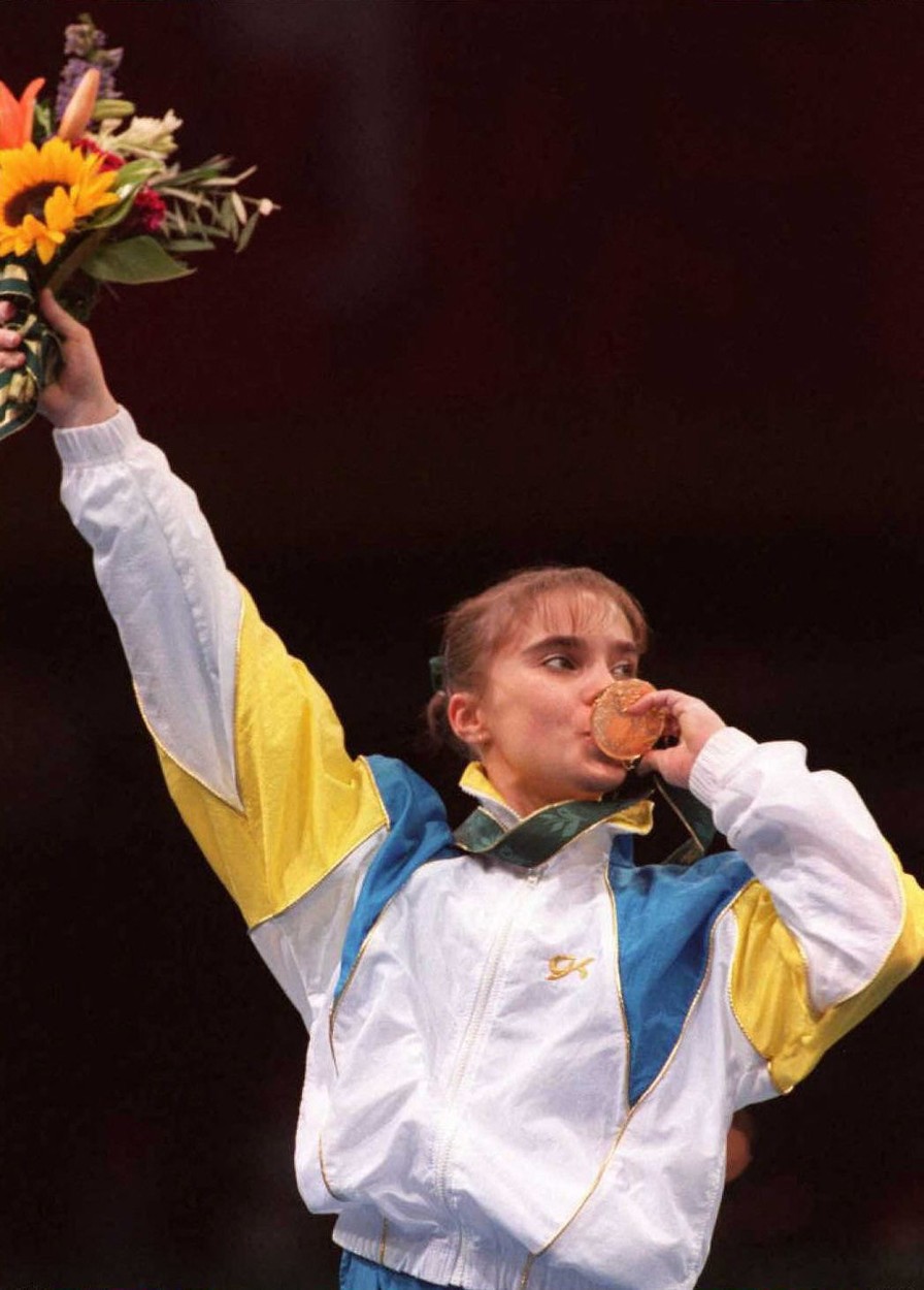 Lilia Podkopayeva from the Ukraine kisses her gold medal after winning the women's individual all-around competition of the Olympic gymnastics event at the Georgia Dome in Atlanta, Georgia, 25 July. Podkopayeva  won  the title with 39.255 points, followed by Gina  Gogean  from Romania with 39.075 points, and fellow Romanians Simona Anamar and Lavinia Milosovici with 39.067. (FOR EDITORIAL USE ONLY) AFP-IOPP/ Eric FEFERBERG,Image: 68510145, License: Rights-managed, Restrictions: , Model Release: no