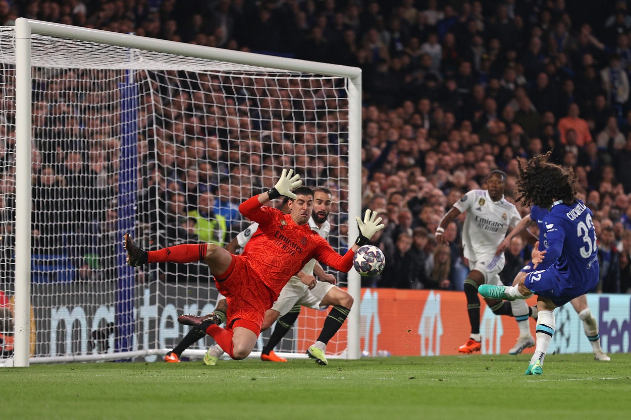 Real Madrid's Belgian goalkeeper Thibaut Courtois (L) savers a shot from Chelsea's Spanish defender Marc Cucurella (L) during the Champions League quarter-final second-leg football match between Chelsea and Real Madrid at Stamford Bridge in London on April 18, 2023.,Image: 770238314, License: Rights-managed, Restrictions: , Model Release: no