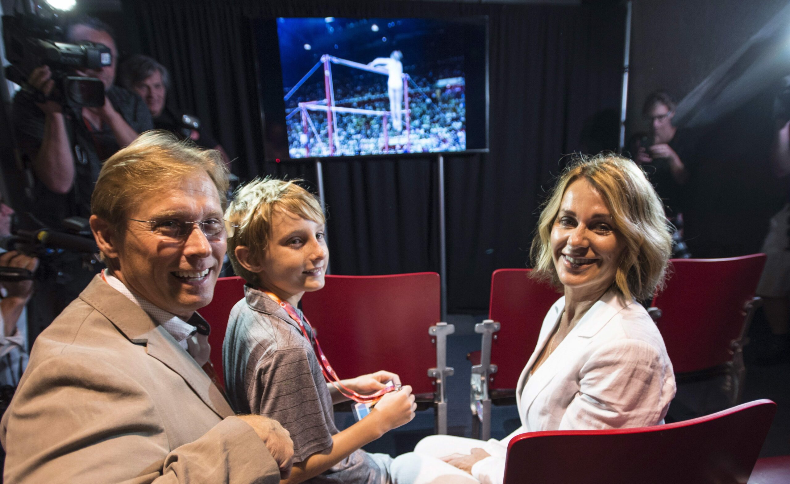 Montreal 1976 Olympics gymnastics champion Nadia Comaneci, her husband Bart Conner and their son Dylan watch a video of her competing as she tours a exhibit marking the 40th anniversary of the Games Thursday, July 21, 2016 in Montreal. Photo by Paul Chiasson/The Canadian Press/ ABACAPRESS.COM