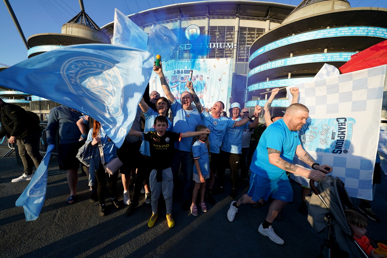 Manchester City fans celebrate outside of the Etihad Stadium after winning the Premier League following the outcome of the Nottingham Forest v Arsenal match. Picture date: Saturday May 20, 2023.,Image: 777737768, License: Rights-managed, Restrictions: , Model Release: no