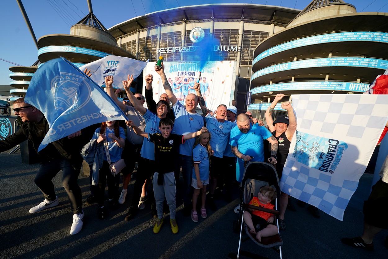 Manchester City fans celebrate outside of the Etihad Stadium after winning the Premier League following the outcome of the Nottingham Forest v Arsenal match. Picture date: Saturday May 20, 2023.,Image: 777737785, License: Rights-managed, Restrictions: , Model Release: no