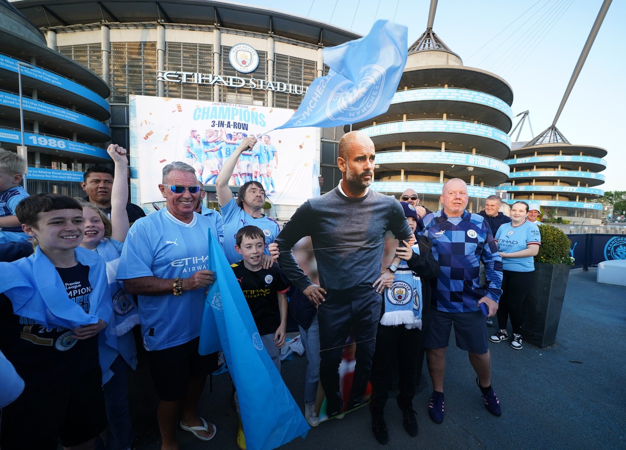 Manchester City fans celebrate outside of the Etihad Stadium after winning the Premier League following the outcome of the Nottingham Forest v Arsenal match. Picture date: Saturday May 20, 2023.,Image: 777744889, License: Rights-managed, Restrictions: , Model Release: no