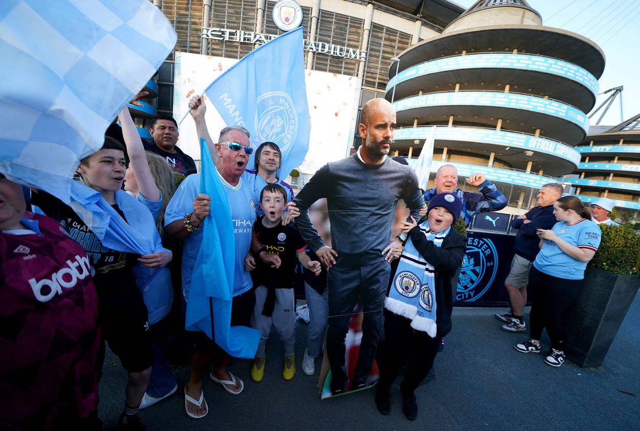 Manchester City fans celebrate outside of the Etihad Stadium after winning the Premier League following the outcome of the Nottingham Forest v Arsenal match. Picture date: Saturday May 20, 2023.,Image: 777744915, License: Rights-managed, Restrictions: , Model Release: no