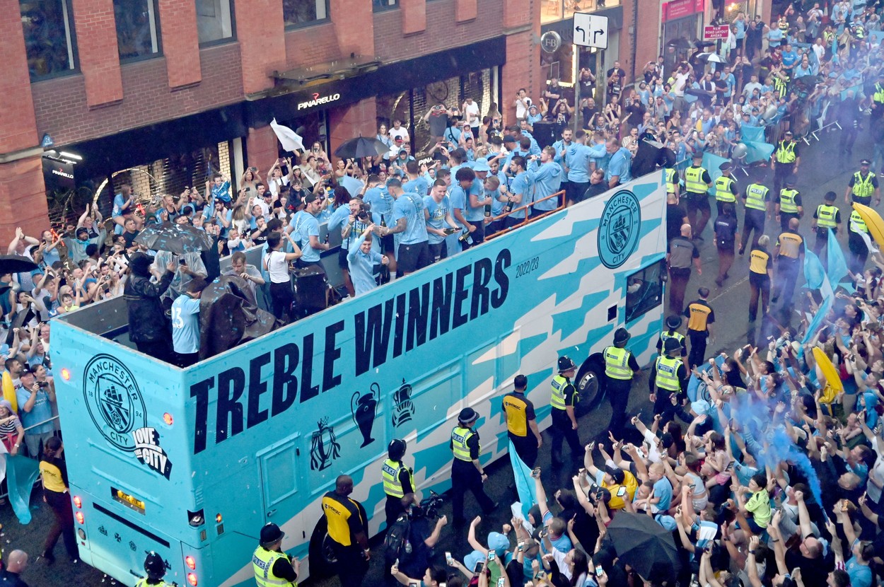 Fans watch Manchester City in their open top bus parade through Manchester City Centre.
Manchester City Treble Parade, Football, Manchester, UK - 12 Jun 2023,Image: 782976629, License: Rights-managed, Restrictions: , Model Release: no