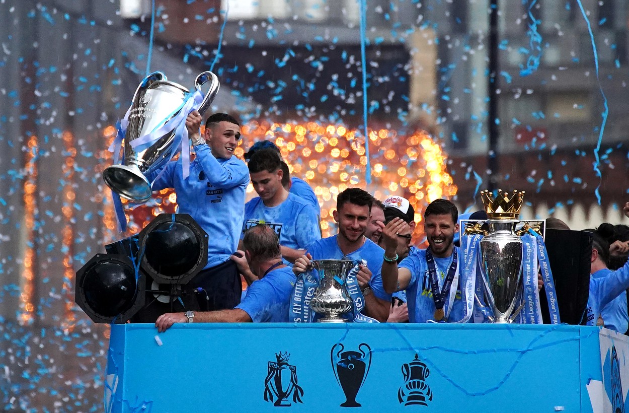 Manchester City's Phil Foden (left) with the Champions League trophy during the Treble Parade in Manchester. Manchester City completed the treble (Champions League, Premier League and FA Cup) after a 1-0 victory over Inter Milan in Istanbul secured them Champions League glory. Picture date: Monday June 12, 2023.,Image: 782977511, License: Rights-managed, Restrictions: Use subject to restrictions. Editorial use only, no commercial use without prior consent from rights holder., Model Release: no