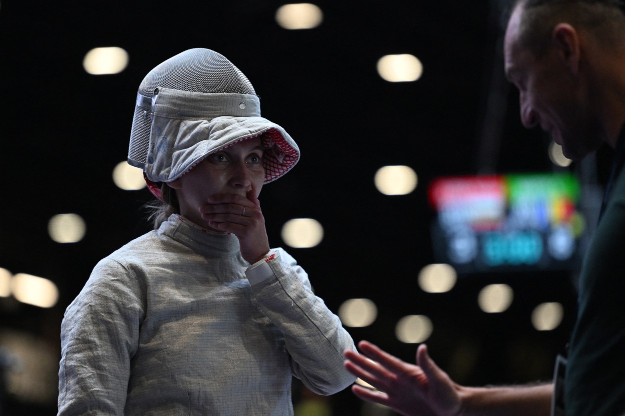 Russia's Anna Smirnova, registered as an Individual Neutral Athlete (AIN), listens to her coach as she competes against Ukraine's Olha Kharlan (not in picture) during the Sabre Women's Senior Individual qualifiers, as part of the FIE Fencing World Championships at the Fair Allianz MI.CO (Milano Convegni) in Milan, on July 27, 2023.,Image: 792299450, License: Rights-managed, Restrictions: , Model Release: no