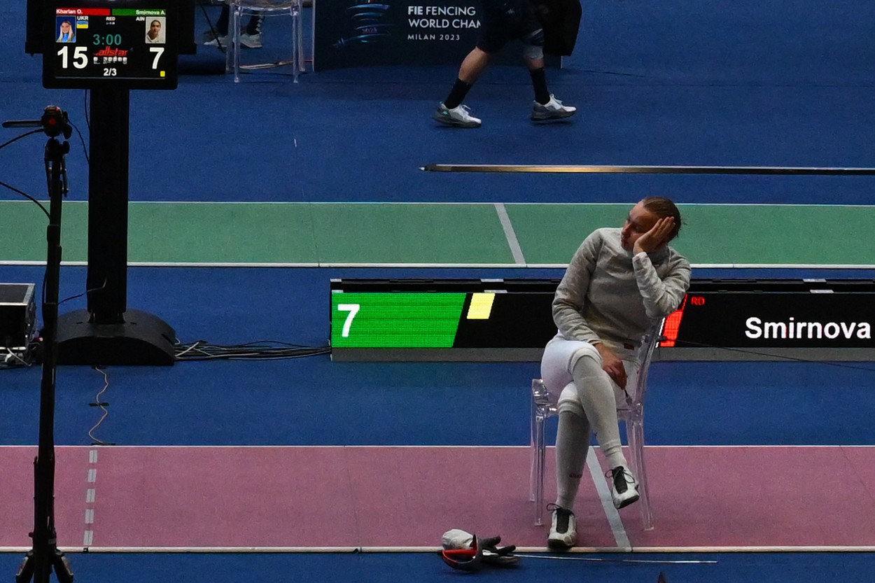 Russia's Anna Smirnova, registered as an Individual Neutral Athlete (AIN), sits on the fencing strip in protest, after Ukraine's Olha Kharlan (not in picture), refused to shake hands with her, after Kharlan defeated her during the Sabre Women's Senior Individual qualifiers, as part of the FIE Fencing World Championships at the Fair Allianz MI.CO (Milano Convegni) in Milan, on July 27, 2023.,Image: 792312939, License: Rights-managed, Restrictions: , Model Release: no