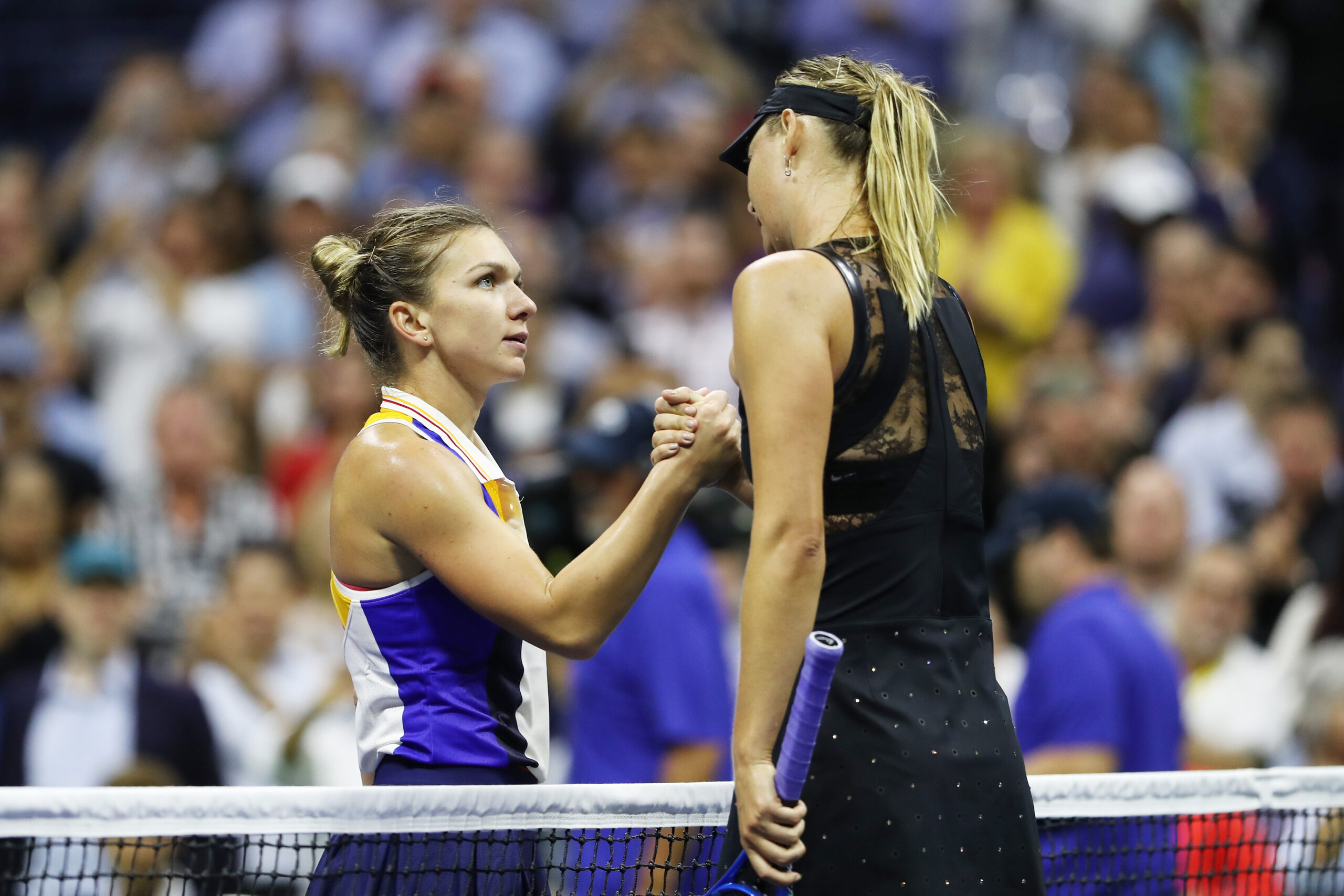NEW YORK, NY - AUGUST 28:  Maria Sharapova (R) of Russia shakes hands with Simona Halep of Romania after defeating her in their first round Women's Singles match on Day One of the 2017 US Open at the USTA Billie Jean King National Tennis Center on August 28, 2017 in the Flushing neighborhood of the Queens borough of New York City.  (Photo by Elsa/Getty Images)