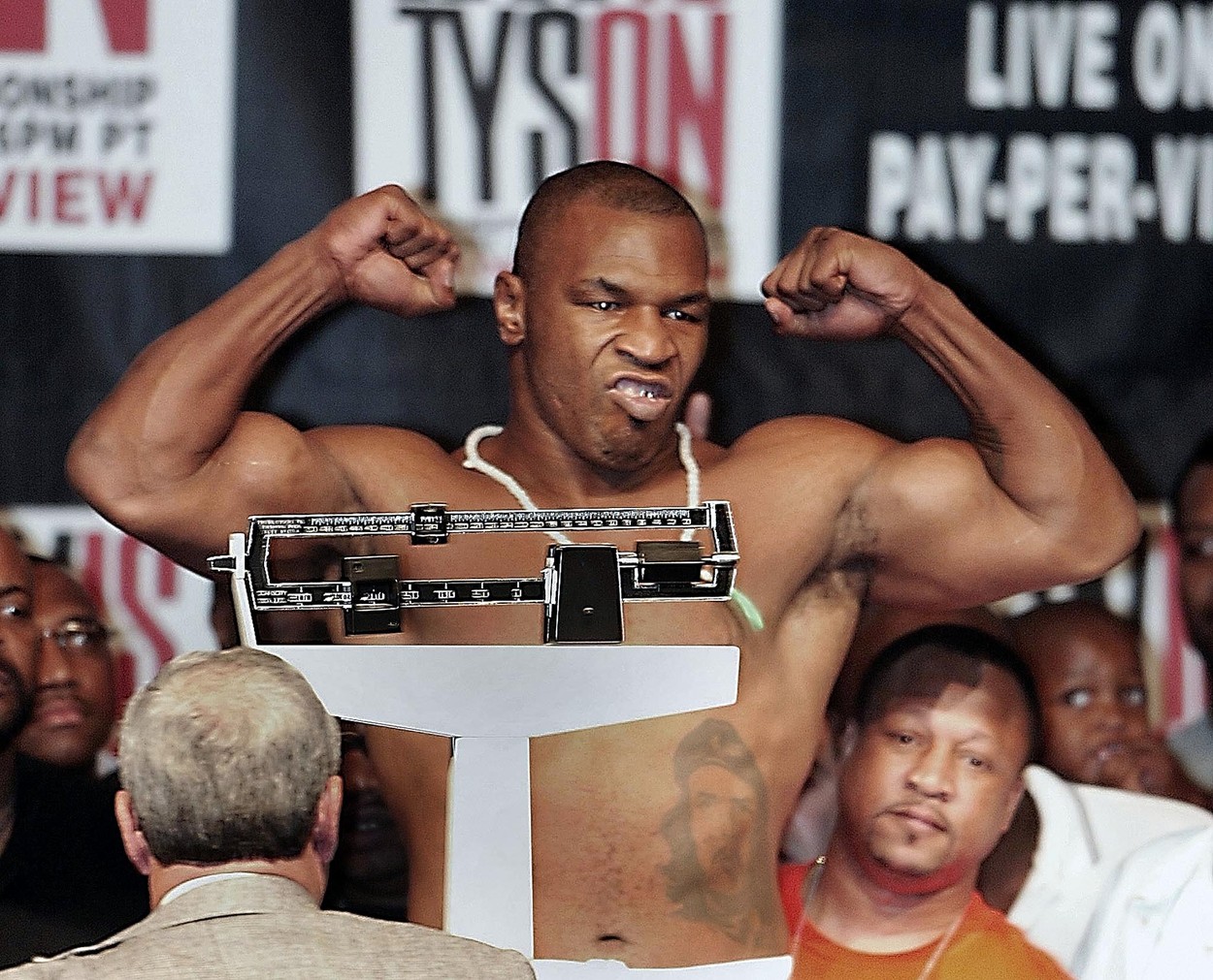 Heavyweight challenger Mike Tyson flexes after weighing in at 234 1/2 pounds in Memphis, Tennessee 06 June, 2002. Tyson  will face the defending champion Lennox Lewis for the WBC/IBF Heavyweight Championship in Memphis 08 June.,Image: 69379561, License: Rights-managed, Restrictions: , Model Release: no