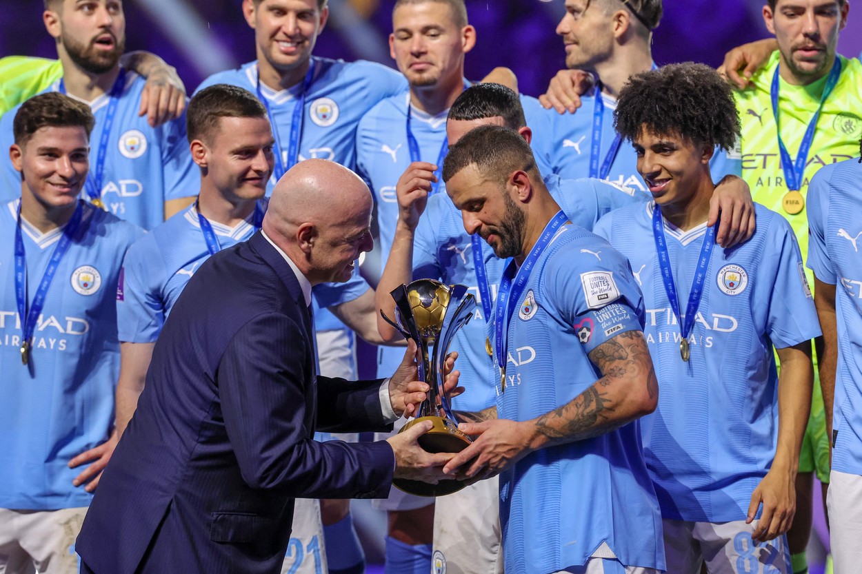 Manchester City's English defender #02 Kyle Walker receives the winning trophy from FIFA President Gianni Infantino at the end of the FIFA Club World Cup 2023 football final match against Brazil's Fluminense at King Abdullah Sports City Stadium in Jeddah on December 22, 2023.,Image: 831834605, License: Rights-managed, Restrictions: , Model Release: no