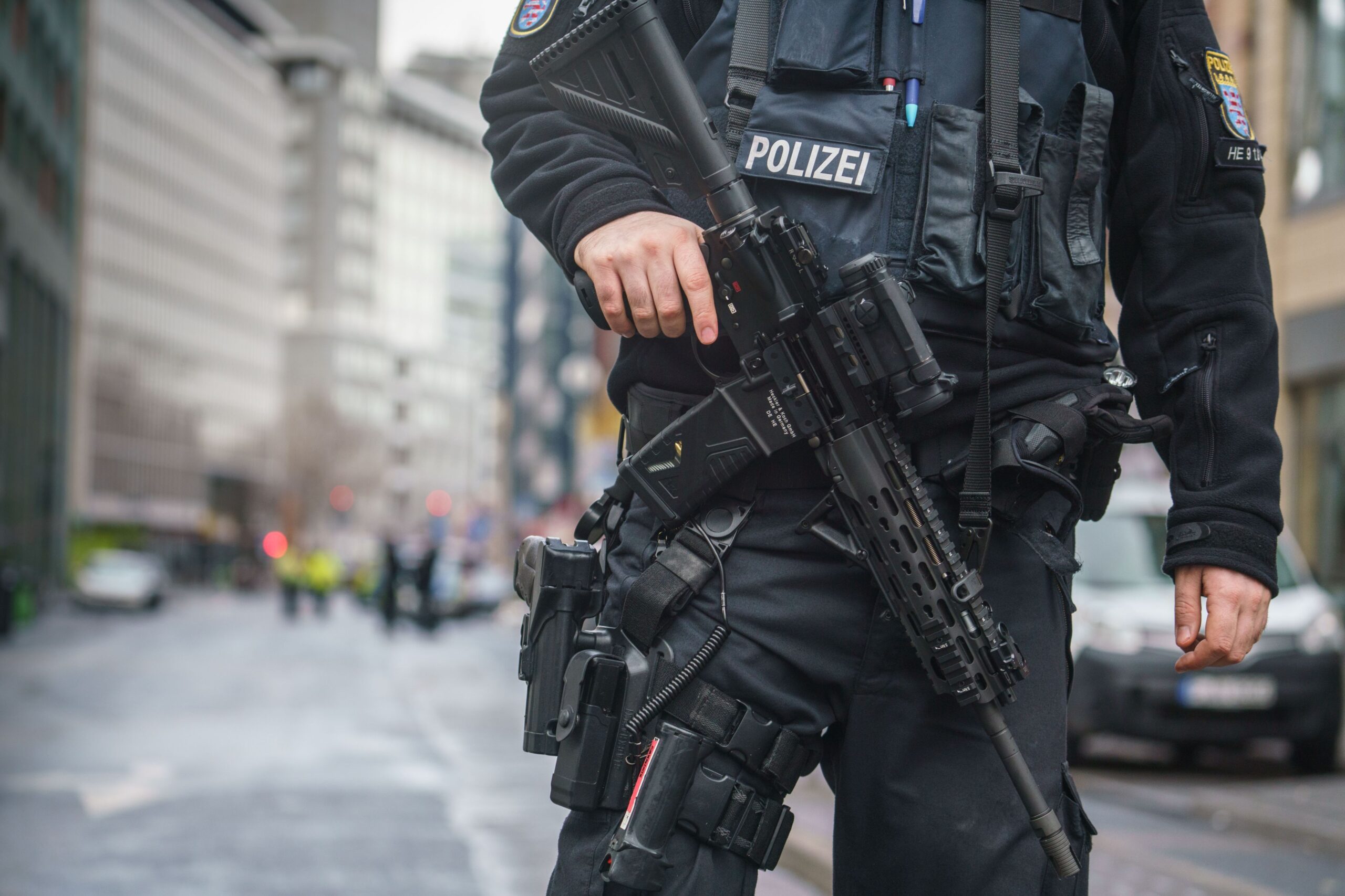 26 January 2021, Hessen, Frankfurt/Main: A police officer cordons off the area in Frankfurt's Bahnhofsviertel district where there was a suspected knife attack this morning that left several people injured. A suspect has been arrested, a police spokesman said. Photo: Frank Rumpenhorst/dpa