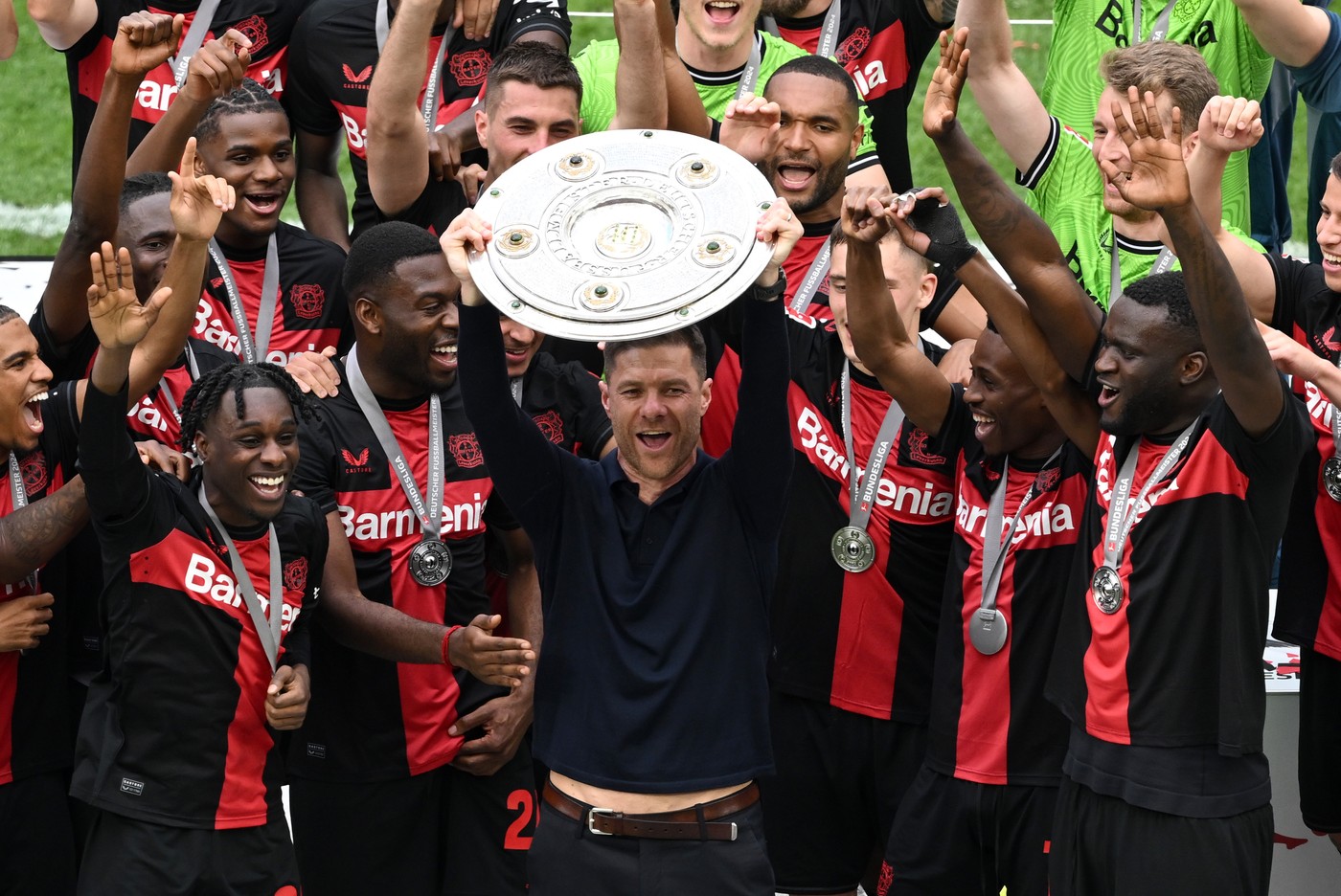 18 May 2024, North Rhine-Westphalia, Leverkusen: Soccer, Bundesliga, Bayer Leverkusen - FC Augsburg, Matchday 34, BayArena, Coach Xabi Alonso (M) celebrates with the championship trophy. IMPORTANT NOTE: In accordance with the regulations of the DFL German Football League and the DFB German Football Association, it is prohibited to use or have used photographs taken in the stadium and/or of the match in the form of sequential images and/or video-like photo series.,Image: 874180007, License: Rights-managed, Restrictions: , Model Release: no
