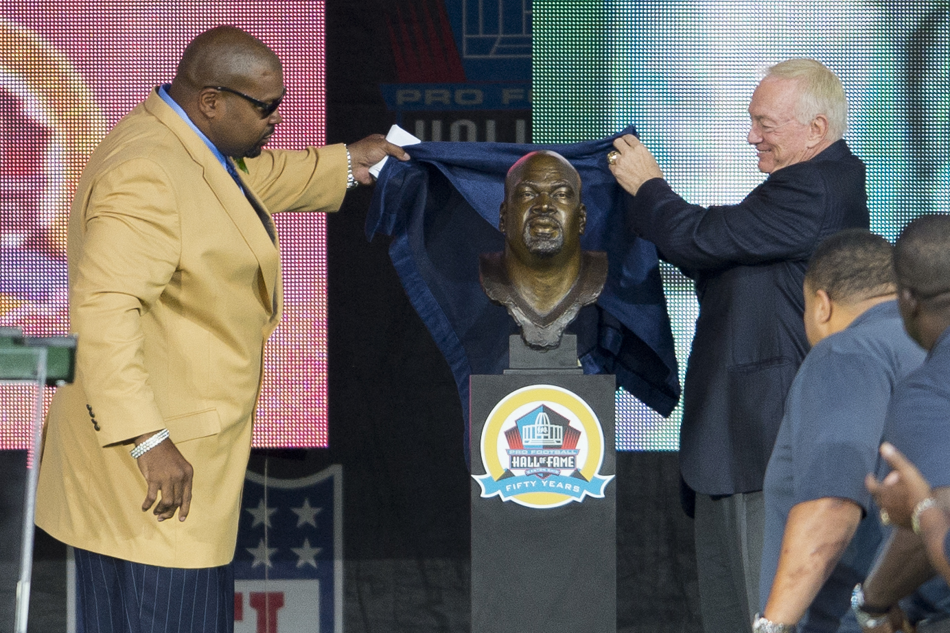 CANTON, OH - AUGUST 3: Dallas Cowboys Owner, President and General Manager, Jerry Jones (R) presents former offensive Lineman Larry Allen of the Dallas Cowboys his Hall of Fame bust during the NFL Class of 2013 Enshrinement Ceremony at Fawcett Stadium on Aug. 3, 2013 in Canton, Ohio.,Image: 167740817, License: Rights-managed, Restrictions: , Model Release: no