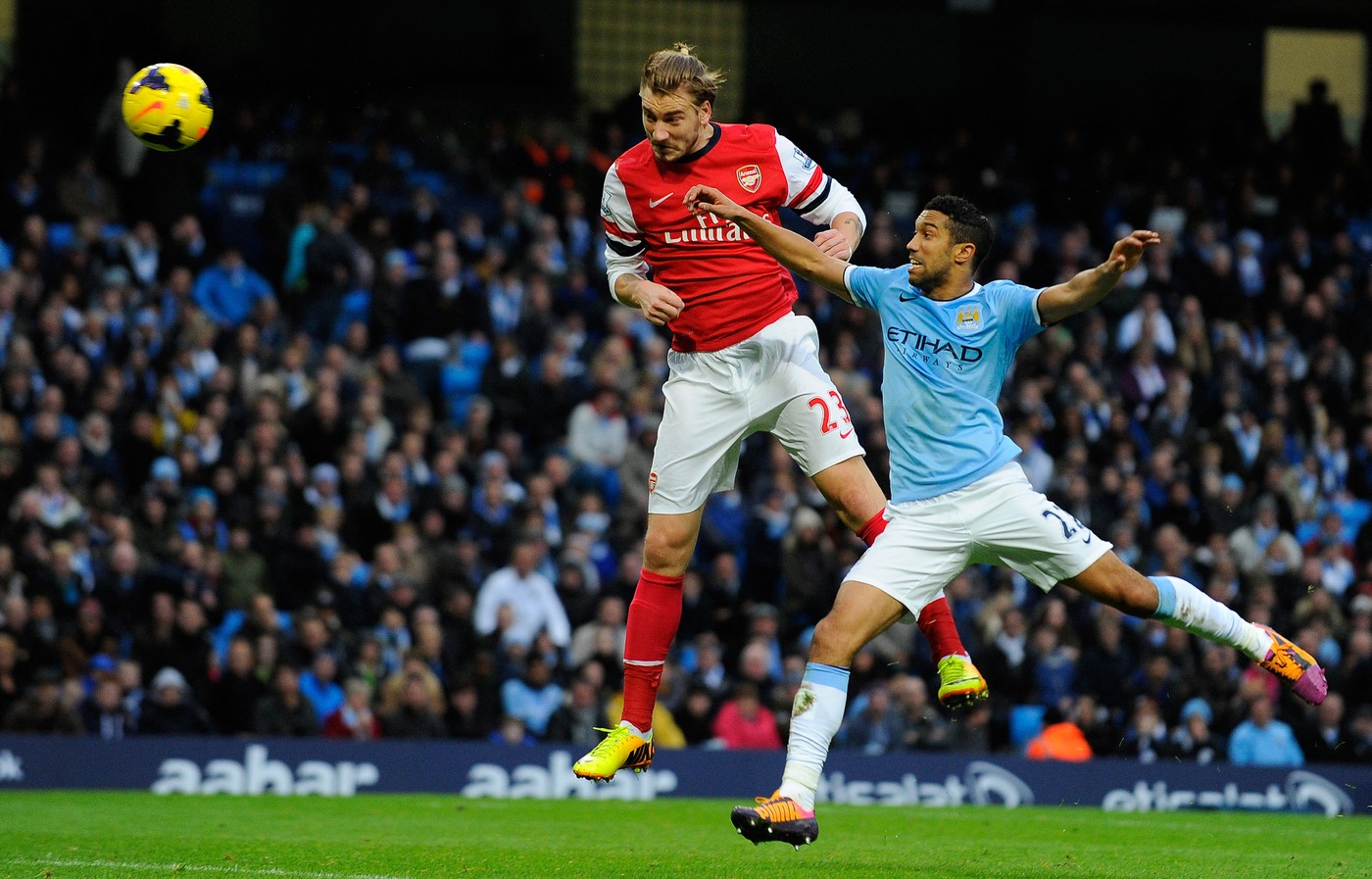 Arsenal's Danish striker Nicklas Bendtner (L) beats Manchester City's French defender Gael Clichy to head into the back of the net only to be ruled offside and the goal dissallowed during the English Premier League football match between Manchester City and Arsenal at the Etihad Stadium in Manchester, northwest England, on December 14, 2013. Manchester City won 6-3.,Image: 179786944, License: Rights-managed, Restrictions: RESTRICTED TO EDITORIAL USE. NO USE WITH UNAUTHORIZED AUDIO, VIDEO, DATA, FIXTURE LISTS, CLUB/LEAGUE LOGOS OR “LIVE” SERVICES. ONLINE IN-MATCH USE LIMITED TO 45 IMAGES, NO VIDEO EMULATION. NO USE IN BETTING, GAMES OR SINGLE CLUB/LEAGUE/PLAYER PUBLICATIONS., Model Release: no