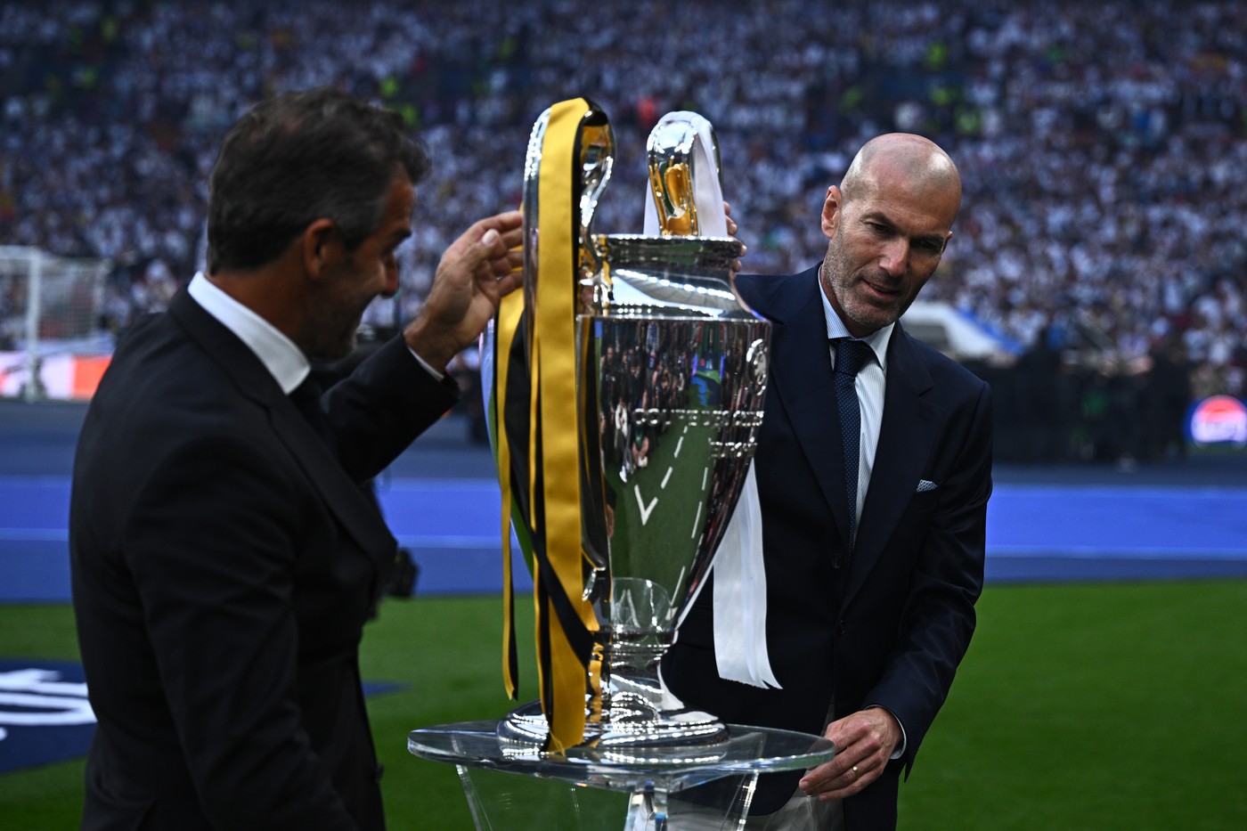 01 June 2024, Great Britain, London: Soccer: Champions League, Borussia Dortmund - Real Madrid, knockout round, final at Wembley Stadium, Zinedine Zidane (r), former soccer player, holds the Champions League trophy before the match.,Image: 878171993, License: Rights-managed, Restrictions: , Model Release: no