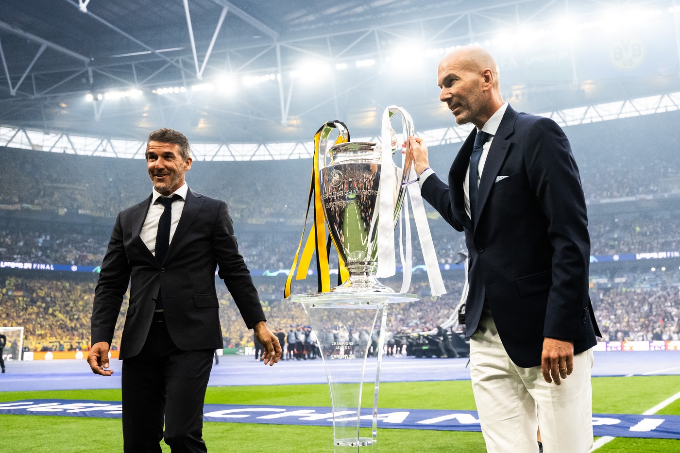 240601 Former players Karl Heinz Riedle and Zinedine Zidane carry the Champions League trophy onto the pitch ahead of the UEFA Champions League final between Dortmund and Real Madrid on June 1, 2024 in London. 
Photo: Petter Arvidson / BILDBYRĹN / kod PA / PA0818
fotboll football soccer fotball champions league final dortmund real madrid bbeng,Image: 878175668, License: Rights-managed, Restrictions: *** World Rights Except Austria, Denmark, Finland, Norway, and  Sweden *** AUTOUT DNKOUT FINOUT NOROUT SWEOUT, Model Release: no