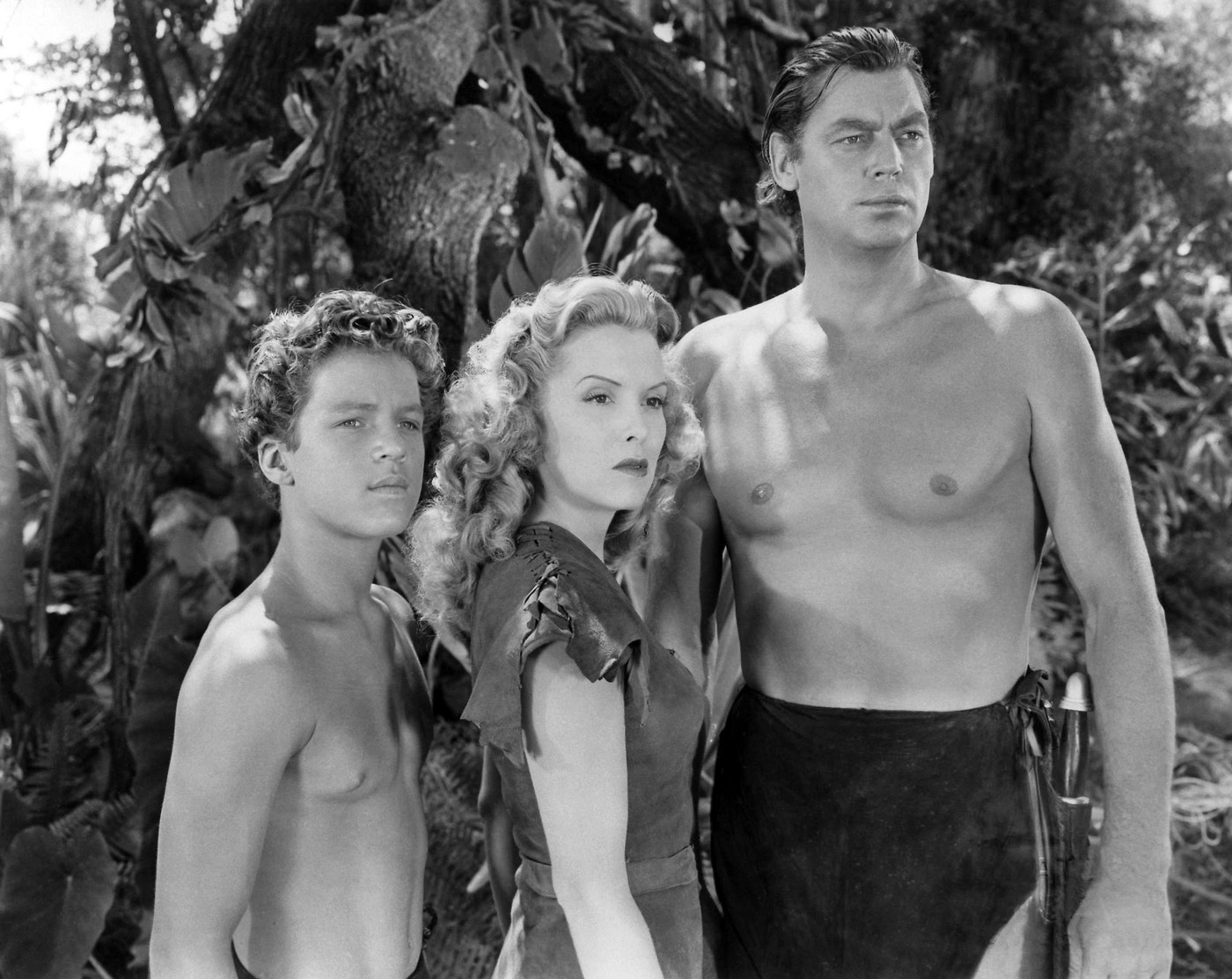Johnny Sheffield, Brenda Joyce & Johnny Weissmuller  Characters: Boy, Jane, Tarzan Film: Tarzan And The Leopard Woman (USA 1946)  Director: Kurt Neumann 08 January 1946     Date: 08-Jan-1946,Image: 418237930, License: Rights-managed, Restrictions: Please use full Credit line: Mary Evans/AF Archive. **Warning** This Photograph is for editorial use only and is the copyright of Rko and/or the Photographer assigned by the Film or Production Company & can only be reproduced by publications in conjunc, Model Release: no