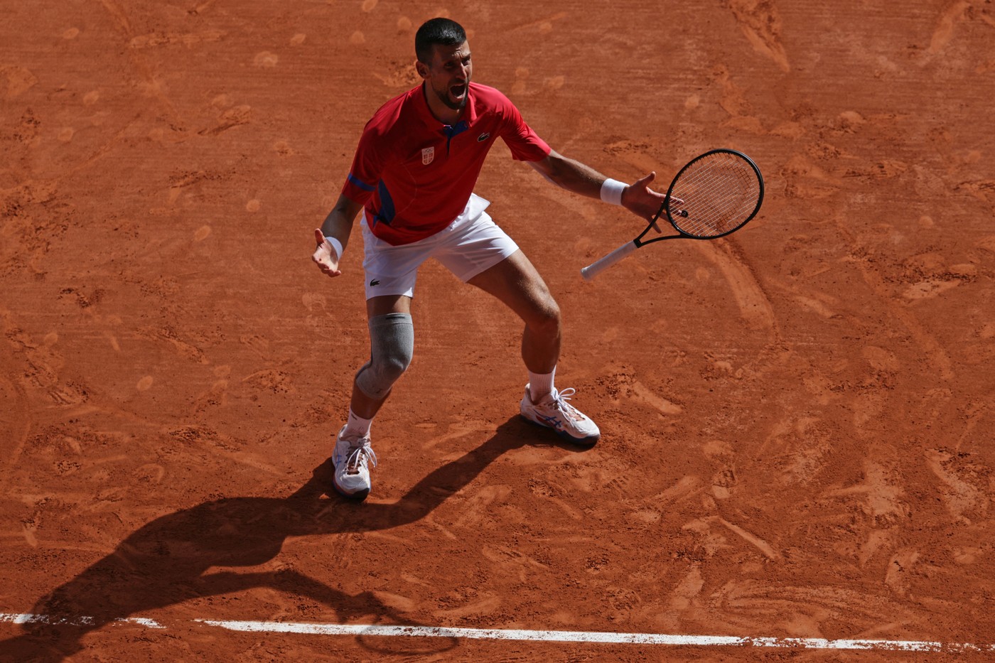Serbia's Novak Djokovic reacts to beating Spain's Carlos Alcaraz in their men's singles final tennis match on Court Philippe-Chatrier at the Roland-Garros Stadium during the Paris 2024 Olympic Games, in Paris on August 4, 2024.,Image: 895900278, License: Rights-managed, Restrictions: , Model Release: no