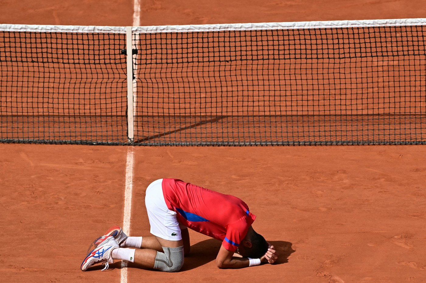 Serbia's Novak Djokovic reacts to beating Spain's Carlos Alcaraz in their men's singles final tennis match on Court Philippe-Chatrier at the Roland-Garros Stadium during the Paris 2024 Olympic Games, in Paris on August 4, 2024.,Image: 895900344, License: Rights-managed, Restrictions: , Model Release: no